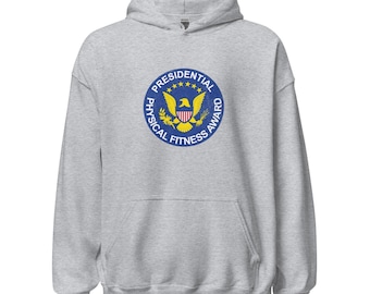 May include: A light gray hooded sweatshirt featuring a circular Presidential Physical Fitness Award emblem. The emblem includes a blue border with white text, a yellow eagle, and stars.