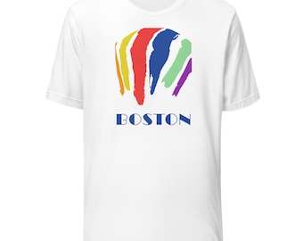May include: White t-shirt featuring a colorful abstract design in yellow, red, blue, green, and purple brushstrokes. The word "BOSTON" is printed in blue below the design. A casual, unisex tee.