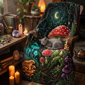 May include: A soft throw blanket draped over a wooden chair, featuring a dark forest scene with a crescent moon, glowing mushrooms in red, blue, and purple, and a small gray kitten sleeping peacefully in the center of the vibrant woodland design.