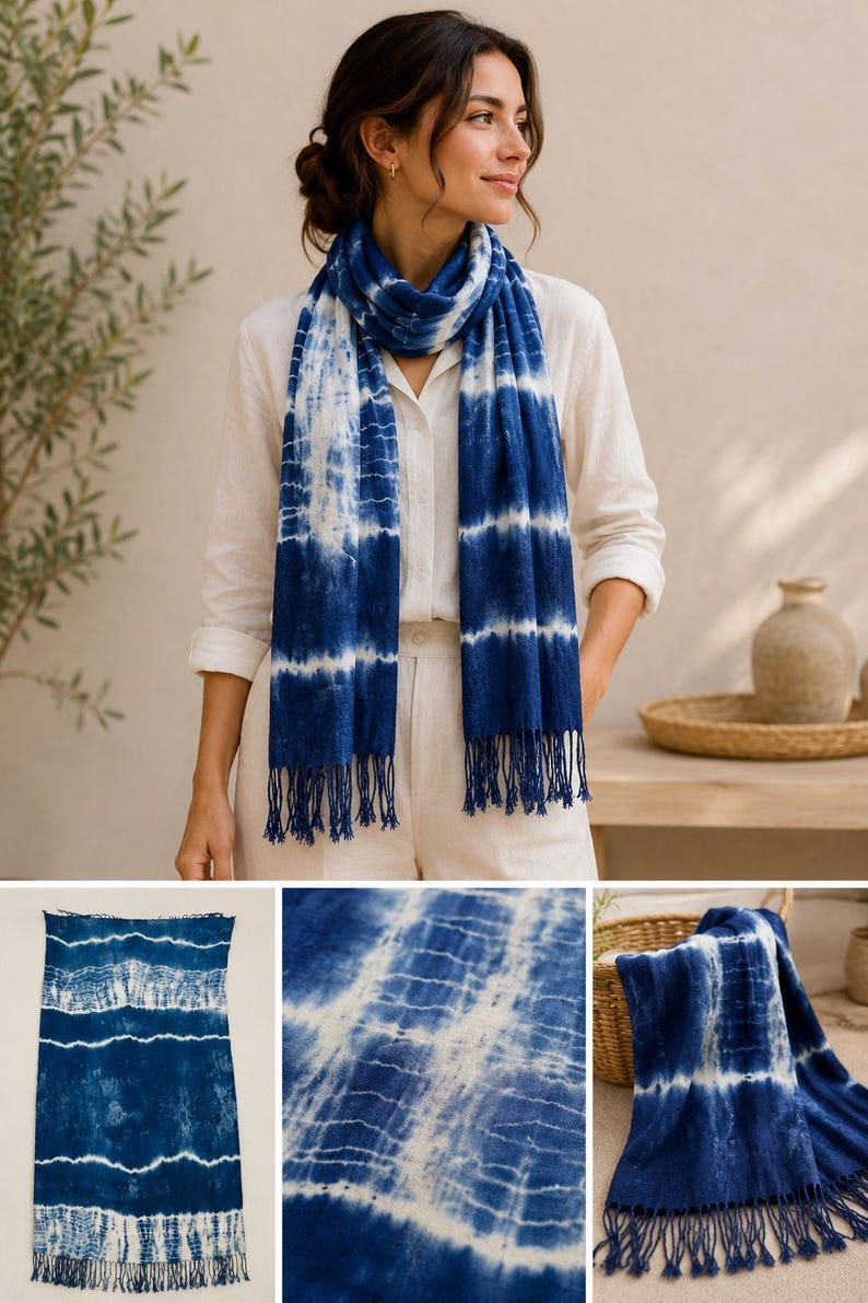May include: A rectangular scarf featuring a deep blue and white tie-dye pattern with horizontal bands and a fringed edge. The fabric displays a gradient of indigo hues transitioning into white, creating a textured, striped appearance throughout the piece.