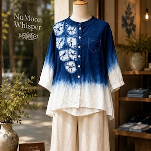 May include: A button-down shirt featuring a deep blue indigo dip-dye gradient, white circular shibori-style patterns on the right chest, a small breast pocket, and three-quarter length sleeves, paired with loose-fitting beige trousers.