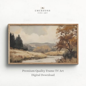 May include: A landscape painting in a light wood frame depicting a river flowing through a field with dark evergreen trees on the left and a large deciduous tree on the right under a cloudy sky. Text above reads EMERSONS FINE ART.
