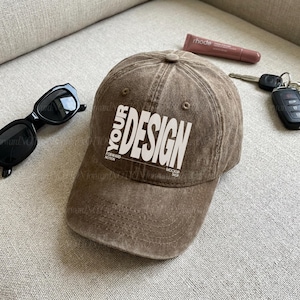 Könnte beinhalten: Eine braune Baseballkappe in Distressed-Optik mit dem weißen Aufdruck YOUR DESIGN, FORWARD MOTION und MOCKUP SHOP auf der Vorderseite. Die Kappe hat eine strukturierte Krone, einen gebogenen Schirm mit Ziernähten und Belüftungsösen.