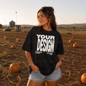 May include: A black short-sleeved t-shirt featuring the white text "YOUR DESIGN" in a bold, sans-serif font, with smaller text below reading "FORWARD NOTION MOCKUP SHOP". The shirt is paired with light blue denim shorts, creating a casual look.