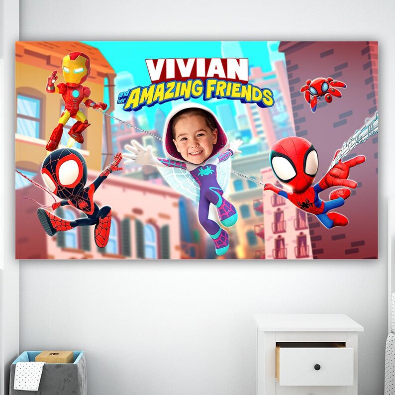 May include: A colourful wall art print displaying the text "VIVIAN and AMAZING FRIENDS" with cartoon characters Iron Man, Spider-Man, and a child dressed as a superhero. The artwork is set against a cityscape backdrop with a blue sky.