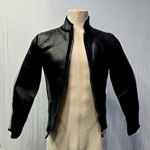 May include: Black leather jacket with a stand-up collar and a full-length zipper. The jacket has a slim fit and white stripes on the sleeves. The jacket is displayed on a mannequin. A classic outerwear piece.