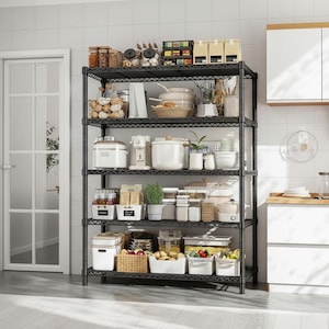 May include: A black metal wire shelving unit filled with kitchen supplies. Jars of spices, white containers, and small appliances are neatly arranged on the shelves. A white door is visible in the background.