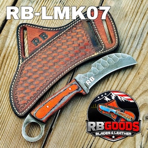 May include: A curved blade knife with an orange and gray handle, and a leather sheath. The knife has a textured blade and a ring at the base of the handle. The sheath is brown with a woven pattern. The text "RB-LMK07" is at the top.