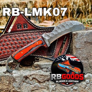 May include: A custom knife with an orange and gray wooden handle and a curved, textured blade. The knife rests on a stone surface with a leather sheath featuring the text "RB-LMK07" and the logo "RB GOODS BLADES & LEATHER".