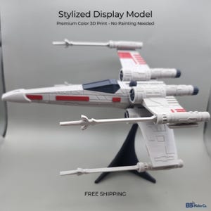 May include: A white and red X-wing starfighter model on a black stand. The model has a detailed design with red accents and is labeled "Stylized Display Model". The text "Premium Color 3D Print - No Painting Needed" is also visible.