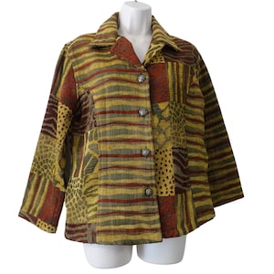 May include: A long-sleeve button-down jacket featuring a patchwork design with alternating panels of horizontal stripes and textured animal-inspired patterns in shades of mustard yellow, olive green, and deep rust red.