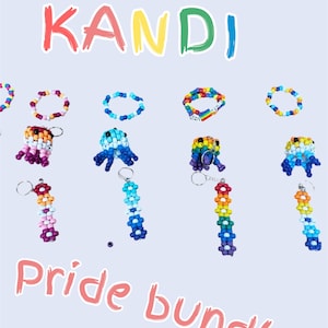 May include: A selection of colourful beaded bracelets and keychains. The word "KANDI" is displayed in rainbow colours, with the text "Pride bundles" below. The accessories are in various colours, including rainbow and pastel shades.