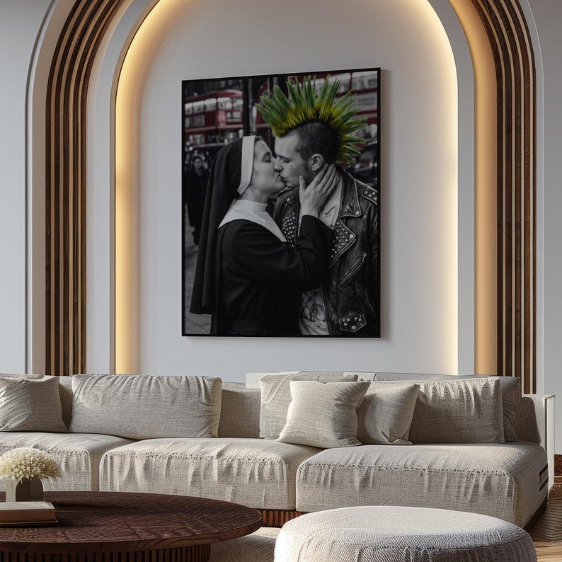 May include: A framed black and white wall art print featuring a nun in a traditional habit kissing a person with a bright green mohawk hairstyle wearing a black leather jacket with metal studs, set against a blurred urban street background.
