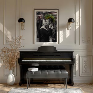 May include: A framed black and white photograph depicting a nun kissing a person with a green mohawk, displayed above a black upright piano with a matching tufted bench. The image features a red bus in the background and is mounted on a wall.