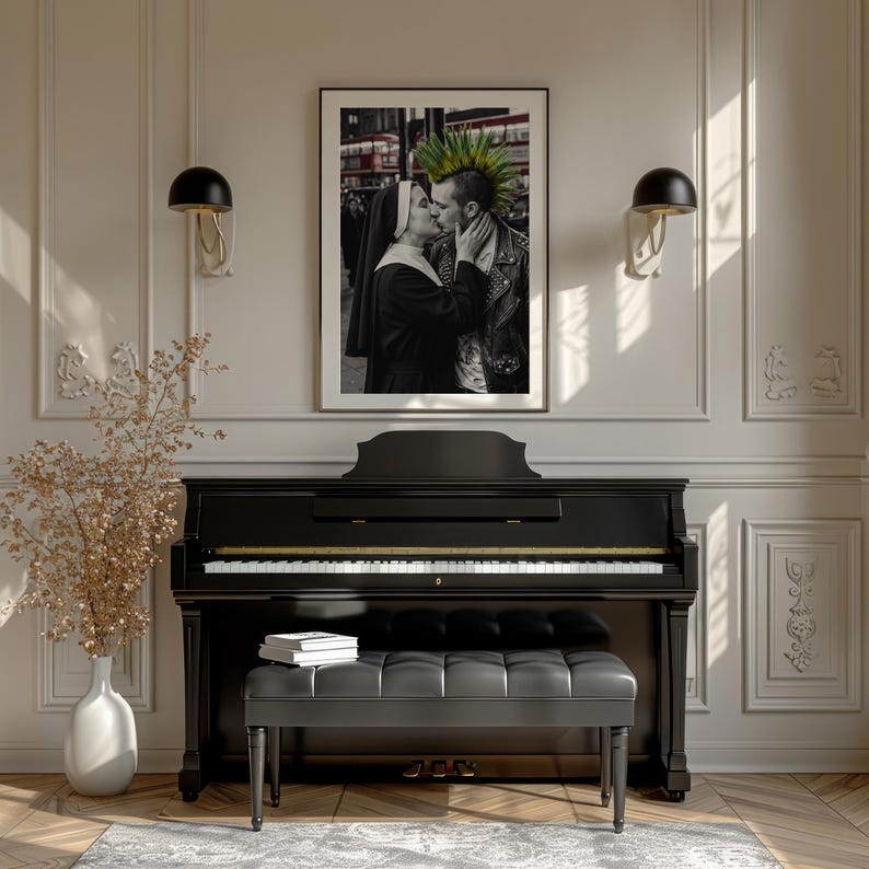 May include: A framed black and white photograph depicting a nun kissing a person with a green mohawk, displayed above a black upright piano with a matching tufted bench. The image features a red bus in the background and is mounted on a wall.