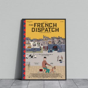 May include: A framed poster for "The French Dispatch" movie, featuring a stylized illustration. The poster has a yellow background with the title in large, bold letters. The image includes a cyclist and a cityscape.