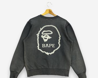 Sudadera vintage BAPE A Bathing Ape negra de la era Nigo con logo grande y gráfico de cabeza de mono, estilo streetwear japonés, talla M.