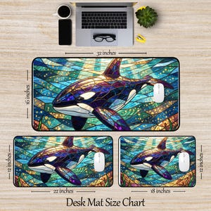May include: A desk mat size chart featuring three mats with a stained-glass orca design. The largest mat is 32 inches long and 16 inches wide. The other two mats are 22 and 18 inches long, and 12 inches wide. The mats have a white mouse on them.
