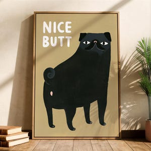 May include: A framed wall art print featuring a black pug dog standing on a tan background. The dog is shown from behind, looking back over its shoulder. The white text "NICE BUTT" is printed in the upper left corner of the rectangular print.