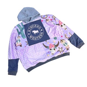 May include: A rustic wooden sign with the text "Welcome to our home" in white lettering. The sign has a distressed finish and a simple, inviting design, ideal for entryway decor.