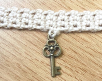 Brass key charm on crochet choker