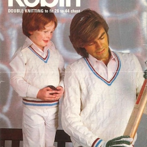 May include: Vintage knitting pattern cover featuring the name "Robin" in large white letters. The cover shows a child and an adult wearing matching cream-colored V-neck sweaters with blue and burgundy trim, paired with white pants. The adult holds a cricket bat.