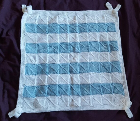Knit baby cot blanket in blue and white