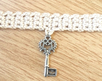 Silver key charm on crochet choker