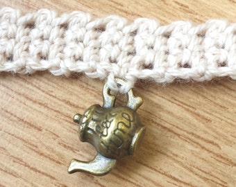 Brass teapot charm on crochet choker