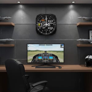 May include: A home office setup with a desk, chair, and computer displaying a flight simulator. Above the desk, a black aviation-style clock hangs on a gray wall, flanked by model airplanes and framed photos. The room has a pilot theme.