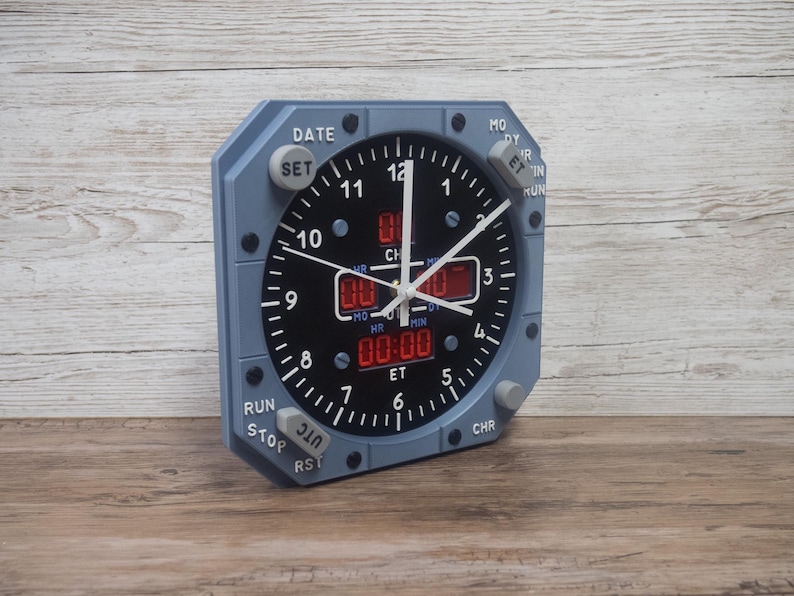 Pilot gift wall clock modeled after an Airbus aircraft cockpit chronometer. This aviation decor features realistic flight instrument details, a grey bezel, and digital time displays.