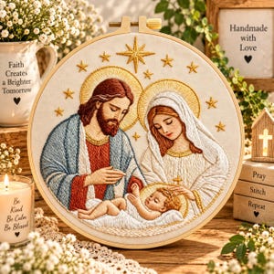 May include: A circular embroidery hoop featuring a detailed thread-stitched depiction of the Holy Family. The design shows a bearded figure in a blue and red robe, a figure in a white veil, and a baby, all surrounded by embroidered gold stars.