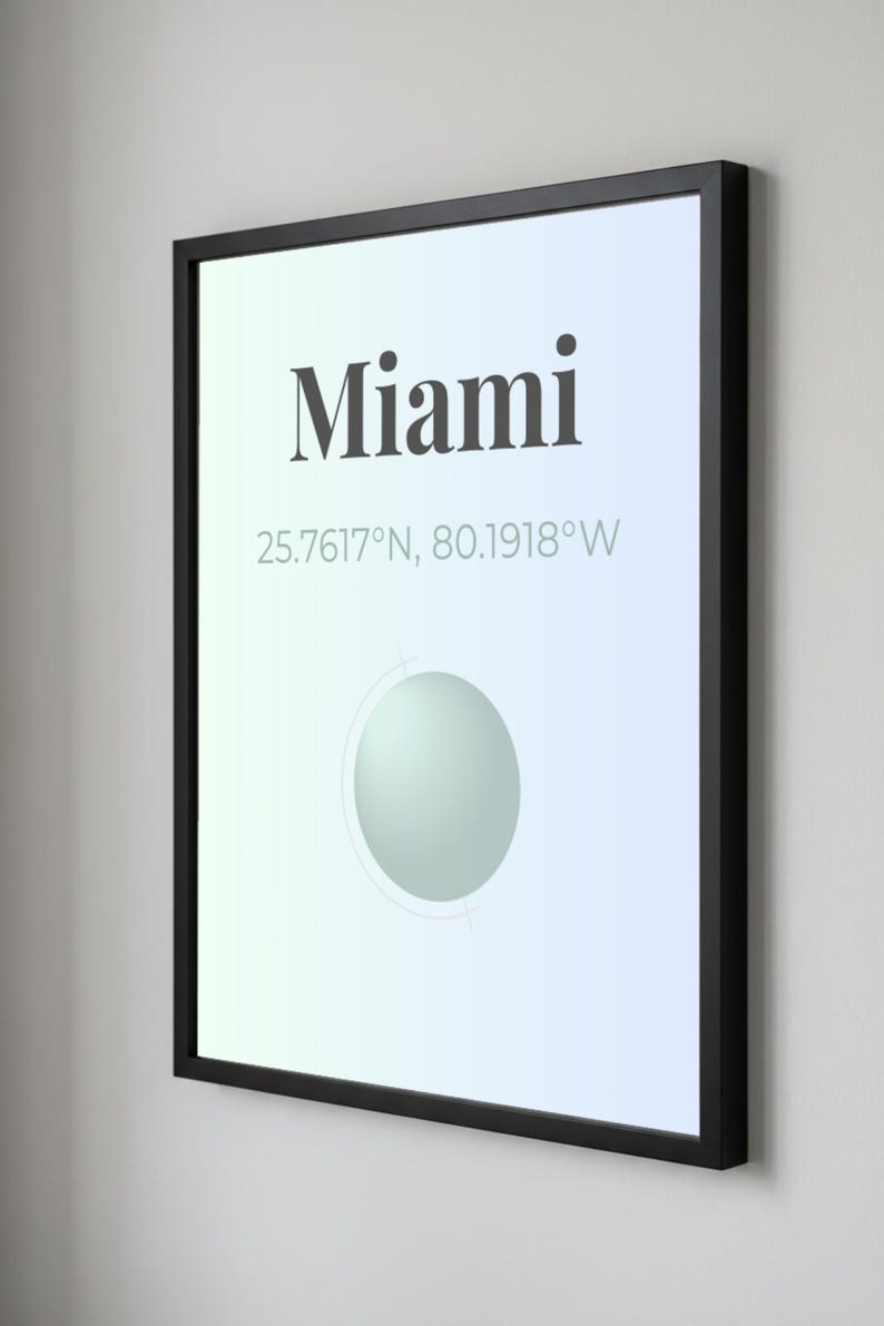May include: Framed art print featuring the city name "Miami" in a bold font, with coordinates 25.7617&deg;N, 80.1918&deg;W. The artwork has a gradient background and a circular design element. The frame is black.