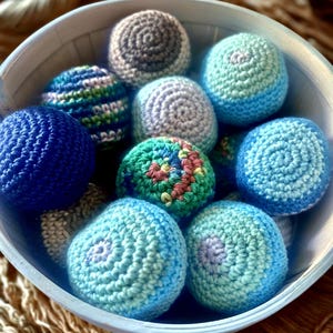 shown in bowl: blue, multicolored green/blue, blue ombré and blue multicolor, rainbow and black ombré