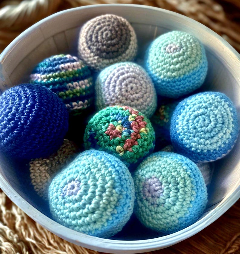 shown in bowl: blue, multicolored green/blue, blue ombré and blue multicolor, rainbow and black ombré