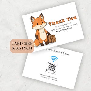 以下が含まれることがあります： 漫画のキツネと「Thank You」の文字が入った2枚の白いカード。キツネはスーツケースを持っています。カードのサイズは12.7 x 8.9 cmです。2枚目のカードにはQRコードとWi-Fi情報が記載されています。
