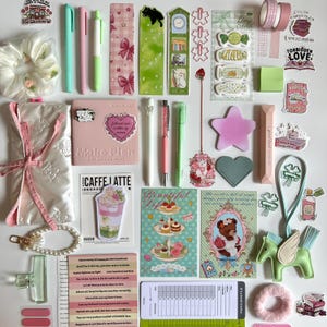 May include: A collection of stationery and accessories in pastel colors. Includes pens, stickers, bookmarks, a planner, washi tape, a scrunchie, and a pearl bracelet. The items are arranged on a white surface, creating a visually appealing flat lay.