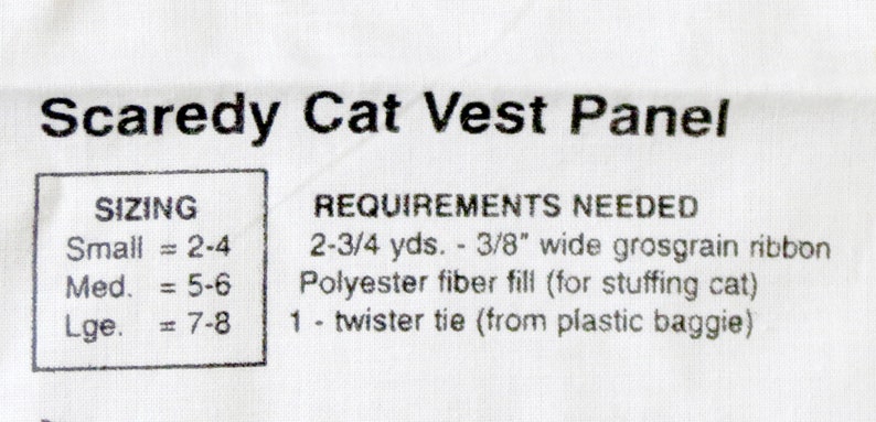 May include: White fabric panel with the text "Scaredy Cat Vest Panel." Includes sizing information for small (2-4), medium (5-6), and large (7-8). Also lists requirements: grosgrain ribbon, polyester fiber fill, and a twister tie.