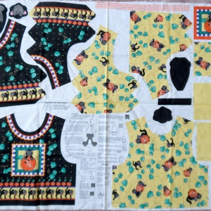 May include: A fabric panel with cut-out pieces for a Halloween-themed vest. The vest features black cats, pumpkins, and a cat in a pumpkin design. The background is black and yellow with green accents.