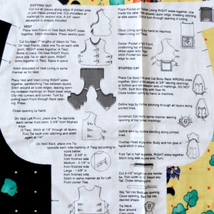 May include: A sewing pattern sheet with instructions and diagrams for making a vest and a stuffed cat. The instructions include cutting, stitching, and assembling the fabric pieces. The sheet has text and illustrations.