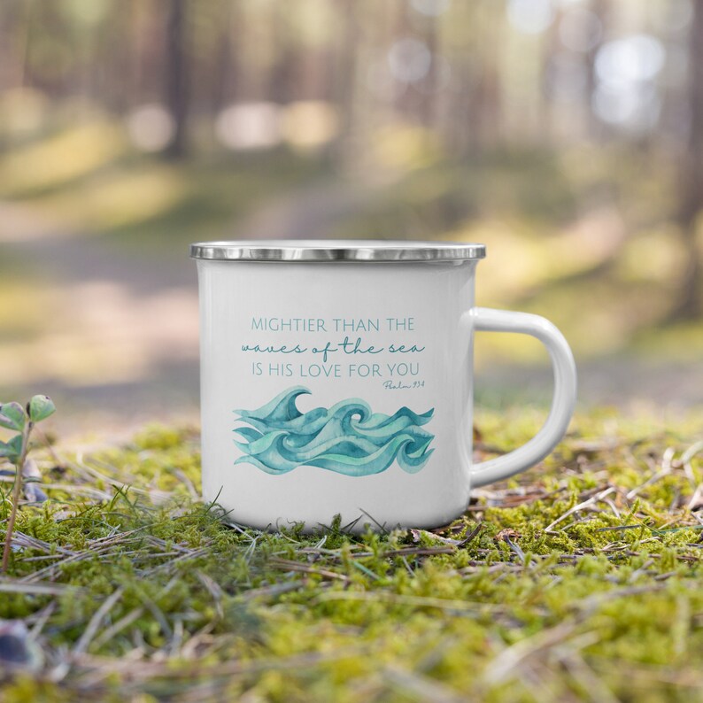 May include: White enamel camping mug with a blue watercolour wave design and the text "MIGHTER THAN THE waves of the sea IS HIS LOVE FOR YOU Psalm 93:4".