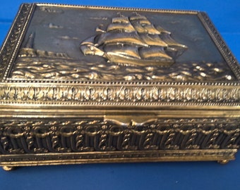 Brass Cigar Box With An Embossed Nautical Clipper Ship and Intricate French Designs on Sides and Fleur de la Lis on Bottom Vtg