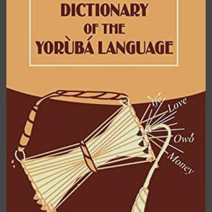 Puede incluir: Portada de libro ilustrada con el título "A Dictionary of the Yoruba Language" en texto marrón oscuro. La imagen incluye un tambor tradicional y una ilustración con las palabras "Love", "Money" y "Life".