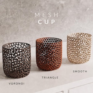 May include: Three decorative mesh cups in varying colors: dark brown, reddish-brown, and gold. The cups have different patterns: Voronoi, Triangle, and Smooth. The text "MESH CUP" is above the cups.