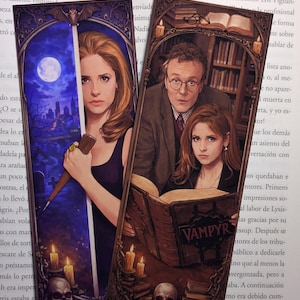 May include: Two decorative bookmarks featuring illustrations. One shows a woman holding a stake with a night sky background. The other depicts a man and woman reading a book with the word "VAMPYR" on it. Skulls and candles are also present.