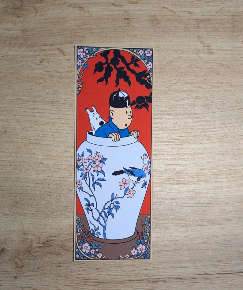 May include: A rectangular bookmark featuring a cartoon illustration of a person in a blue shirt and a small white dog emerging from a large white ceramic vase decorated with blue and pink floral patterns, a blue bird, and a vibrant red background.