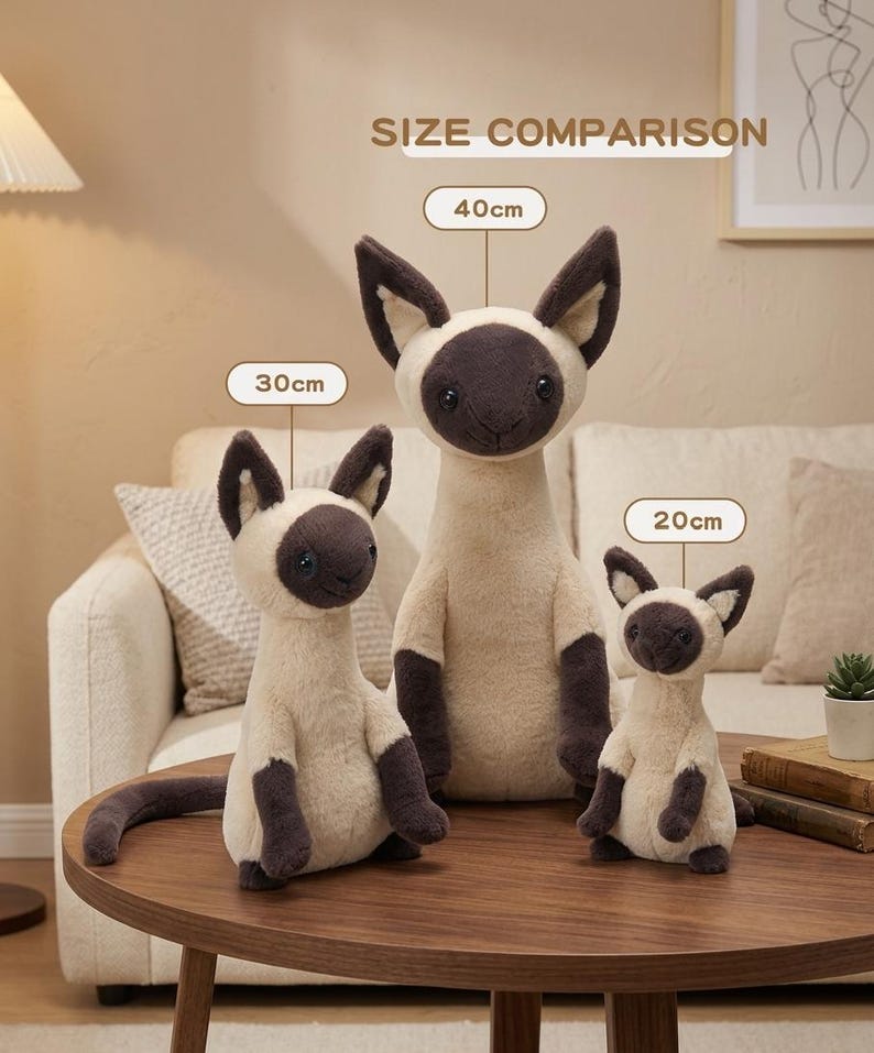 May include: Three plush Siamese cat toys of varying sizes (20cm, 30cm, and 40cm) are displayed on a wooden table. The toys have cream-colored bodies, dark brown faces, ears, paws, and tails. The text "SIZE COMPARISON" is above the toys.