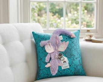 Portachiavi in peluche a forma di drago viola Jellycat, un compagno di giochi morbido e divertente.