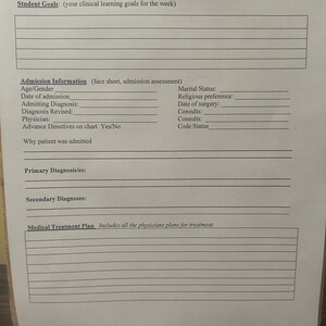 May include: A white paper titled "Patient Care Data Base" with fill-in fields for student information, goals, and medical details. Includes sections for admission information, diagnoses, and treatment plans. The paper is held by a black clipboard.