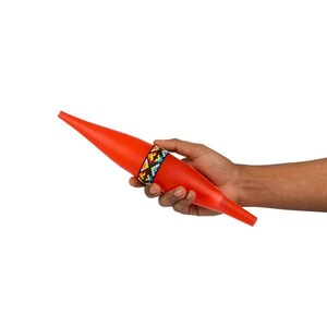 May include: A long, tapered, bright orange plastic object with a pointed end. The center of the object features a decorative band with a colorful, geometric, multi-patterned bead design in shades of blue, yellow, red, and black against a white base.